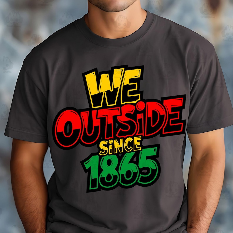 May include: Dark gray t-shirt with the text "WE OUTSIDE SINCE 1865" in yellow, red, green, and black. The shirt has a crew neck and short sleeves. The text is in a bold, stylized font.