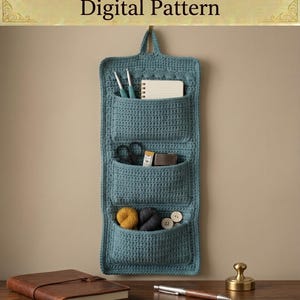 May include: A teal blue crochet pocket organizer with three vertical storage compartments. The text CROCHET POCKET ORGANIZER Digital Pattern is at the top, and INSTANT DOWNLOAD HIGH QUALITY DIGITAL PATTERN is at the bottom of the image.