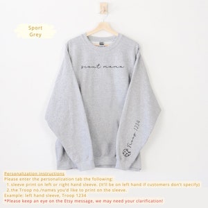 May include: Gray sweatshirt with the text "scout mama" printed on the front and "Troop 1234" printed on the left sleeve.
