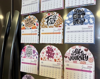 May include: A collection of 2026 January calendars with inspirational quotes and floral designs. Each calendar is a magnet, with a unique design and color scheme, including pink, purple, and blue.
