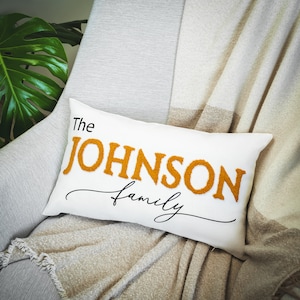 a white pillow with the name of a family on it