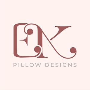 May include: A logo for a business called "Pillow Designs" featuring a stylized "K" with a decorative flourish and a square with a star inside.