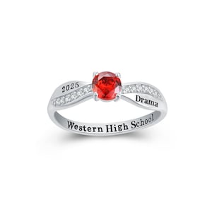 May include: Silver ring with a red gemstone and the inscription "Western High School, Drama, 2025".