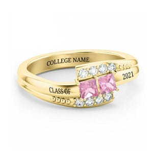 May include: Gold ring with two pink square stones and a band engraved with "COLLEGE NAME" and "CLASS OF 2021".