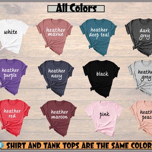 May include: A selection of t-shirts in various colors, including white, heather mauve, heather deep teal, dark grey, heather purple, heather navy, black, heather grey, heather red, heather maroon, pink, and heather peach. The text "All Colors" is at the top of the image. The text "SHIRT AND TANK TOPS ARE THE SAME COLOR" is at the bottom of the image.