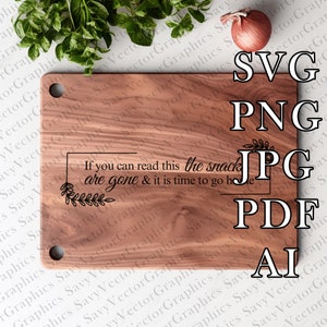 May include: A wooden cutting board with the text "If you can read this the snacks are gone & it is time to go home" printed on it. The board has a natural wood grain and a round hole in the top left corner.