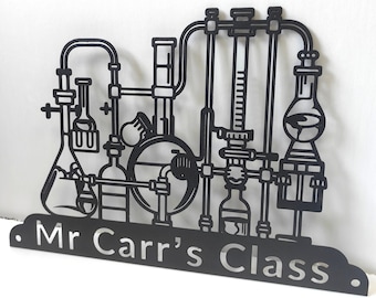 May include: Black metal classroom sign with a silhouette of laboratory equipment, including beakers, flasks, and tubing. The sign reads "Mr. Carr's Class."