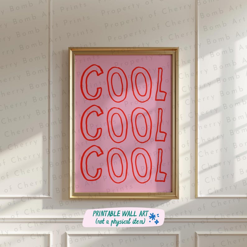 May include: A framed pink wall art print featuring the word "COOL" in red, outlined letters, repeated three times. The print is in a gold frame and includes the text "PRINTABLE WALL ART (not a physical item)" at the bottom.
