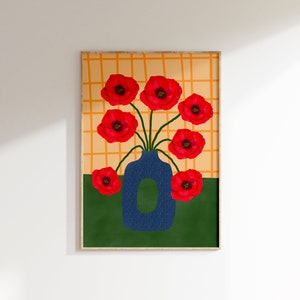 May include: A framed print of a blue vase with red poppy flowers against a yellow and orange checkered background.