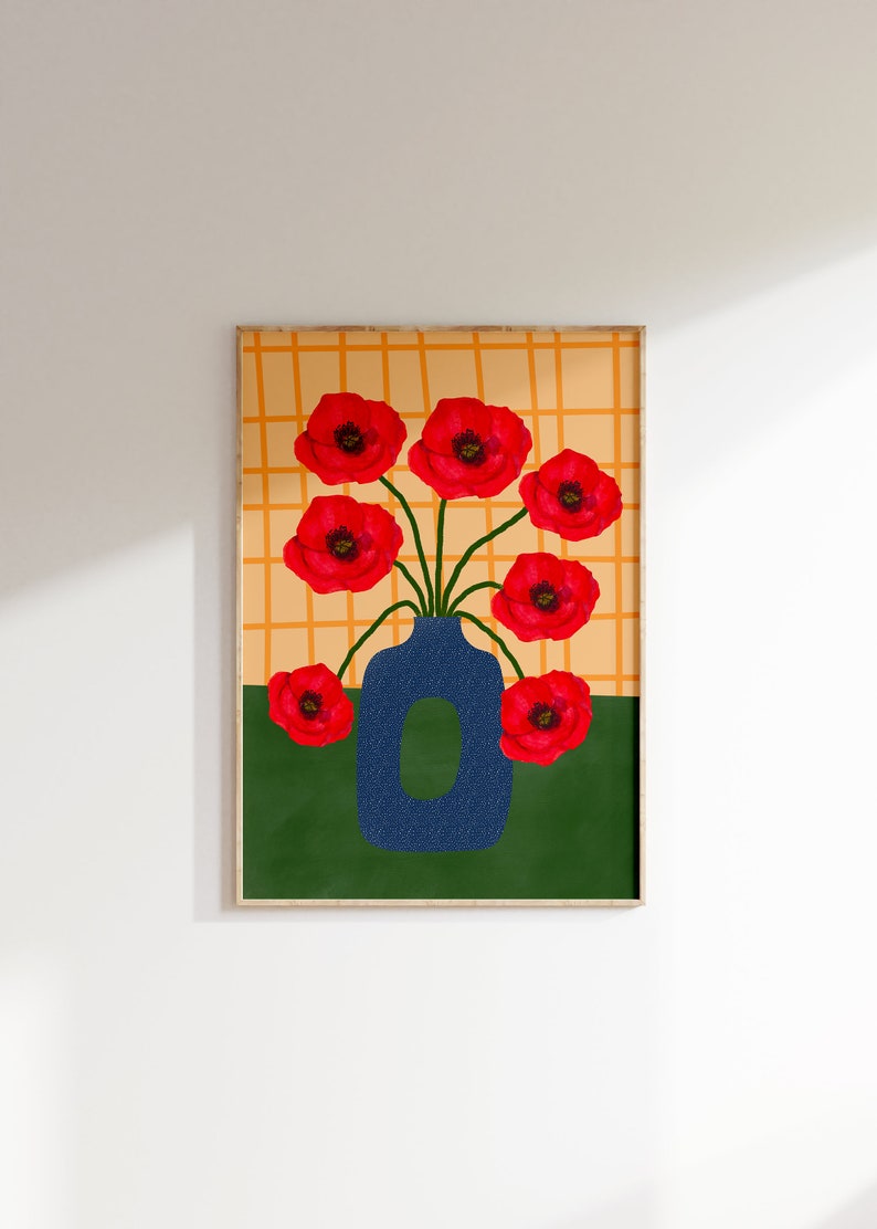 May include: A framed print of a blue vase with red poppy flowers against a yellow and orange checkered background.