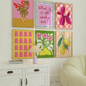 May include: Six framed art prints with vibrant designs. The prints feature a pink floral arrangement, the text "What if it all works out?", a pink balloon dog, pink gummy bears, a floral arrangement, and lemons.