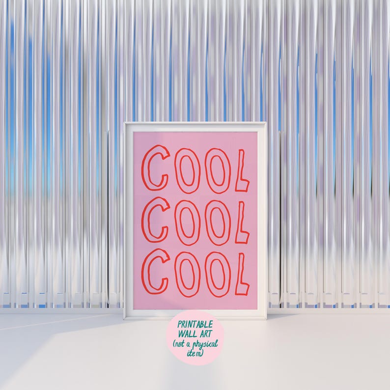 May include: A framed pink print with the word "COOL" repeated three times in red. The print is in a white frame and has a small pink circle with text at the bottom that reads "PRINTABLE WALL ART (not a physical item)".