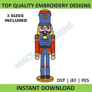 May include: Digital embroidery design of a nutcracker soldier. The design features a blue uniform with red accents, a black mustache, and a tall blue hat. Text includes "TOP QUALITY EMBROIDERY DESIGNS", "3 SIZES INCLUDED", and "INSTANT DOWNLOAD".