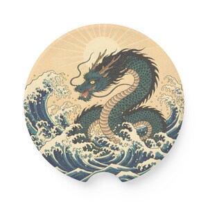 May include: Round car coaster featuring a teal dragon with a long, serpentine body, set against a backdrop of ocean waves and a rising sun. The design is reminiscent of traditional Japanese art, with a vintage aesthetic.