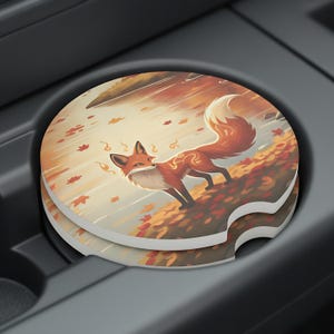May include: A pair of car coasters featuring a fox illustration in autumn colors. The fox is depicted with a fluffy tail and decorative markings, standing among falling leaves. The coasters are round and fit in a car cup holder.
