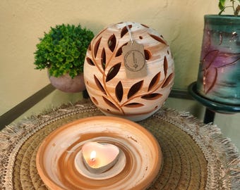Handmade ceramic ball-shaped candle holder decorated with vines and a plate for candles or for burning incense tablets.