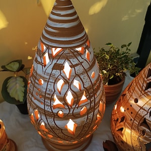 Handcrafted ceramic lamp with a pyramidal shape ending in a peak, with an installed ceramic holder for light bulbs.
