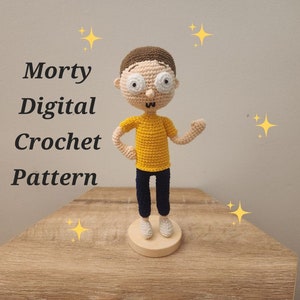 May include: A crocheted figure of Morty from the animated series, wearing a yellow shirt, blue pants, and white shoes. The figure has brown hair and large, round glasses. The text "Morty Digital Crochet Pattern" is displayed.