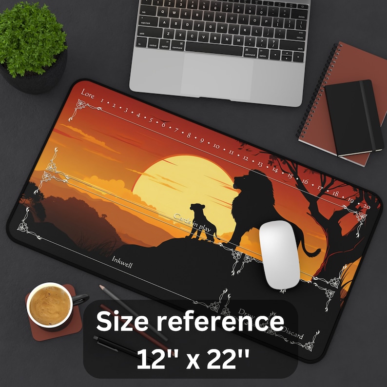 May include: A black mousepad with a sunset scene featuring two lions in silhouette. The mousepad has a ruler printed on the bottom edge, with the text "Lore", "Cares in play", "Inkwell", and "Discard". The mousepad measures 12 inches by 22 inches.