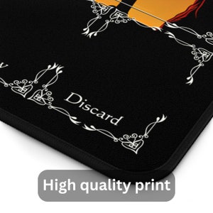 May include: Black mouse pad with white decorative borders and the word "Discard" in white text.