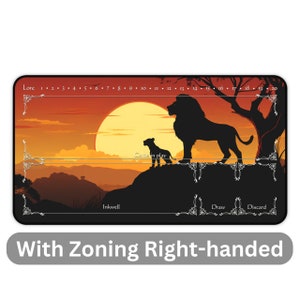May include: A black and white illustration of a lion and a lion cub standing on a rock against a sunset background. The illustration is on a black playmat with a white border and the words "Lore", "Inkwell", "Cards in play", "Draw", and "Discard" printed on it. The numbers 1 through 20 are printed along the top of the playmat.