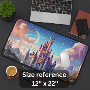May include: A large rectangular mousepad featuring a fantasy castle scene with a blue and pink color scheme. The mousepad has a size reference of 12" x 22". A white mouse is on the pad, and a laptop and coffee cup are in the background.