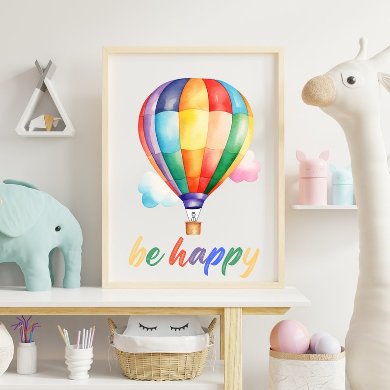 May include: A framed watercolor print of a rainbow hot air balloon with the text "be happy" in colorful letters. The balloon is flying in the sky with clouds.