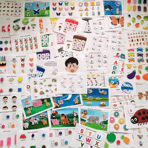 May include: A collection of colorful educational flashcards for children. The cards feature various themes, including colors, letters, numbers, shapes, and animals. The cards are designed to help children learn and develop their cognitive skills.