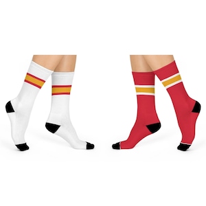 May include: Two pairs of socks with a red and yellow stripe design. One pair is white with a red stripe and a yellow stripe. The other pair is red with a yellow stripe and a white stripe.