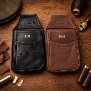 May include: Two leather cartridge pouches, one black and one brown, each featuring the embossed text JACK PYKE OF ENGLAND and the gold-stamped initials EGH. The pouches have a flap top, a front pocket, and stitched edges, designed for carrying shells.