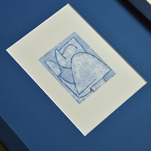 May include: Abstract blue ink drawing in a white mat, set in a dark blue frame. The artwork features a minimalist design with geometric shapes and lines. The frame is a deep navy blue, creating a striking contrast with the artwork.