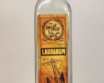 Glass bottle with decorative label "Laudanum"