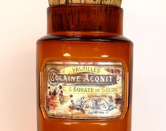 Large, empty, antique apothecary jar in brown glass with a decorative label reading "Cocaine, Aconite & Sodium Borate"