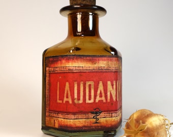 Empty amber glass pharmacy or apothecary bottle with decorative "Laudanum" label
