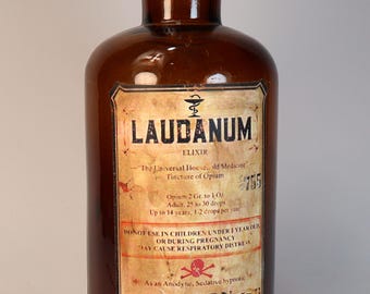 Empty amber glass pharmacy or apothecary bottle with decorative "Laudanum" label