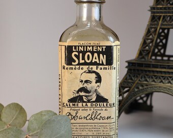 Vintage, empty glass pharmacy bottle with its original label: SLOAN LINIMENT