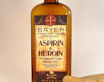 Antique amber glass pharmacy or apothecary bottle, empty, with decorative label creation
