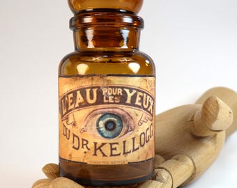 Small, old, empty brown glass pharmacy bottle with a decorative label design: "Dr. Kellogg's Eye Water"
