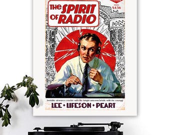 May include: A framed vintage poster titled "The Spirit of Radio" featuring a man wearing headphones, set against a red circular backdrop. The poster includes the text "LEE • LIFESON • PEART" and the price $4.56.