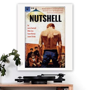 May include: A framed print of the "Nutshell" album cover. The artwork shows a shirtless man from behind, with text and figures in the background. The album is by Jerry Cantrell, Mike Inez, Sean Kinney, and Layne Staley.
