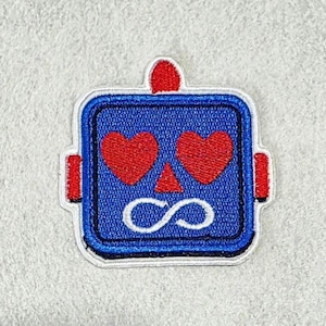 May include: A square-shaped embroidered patch featuring a blue robot head with two red heart-shaped eyes, a small red triangular nose, and a white infinity symbol for a mouth. The robot has a red antenna on top and red side panels on each side.
