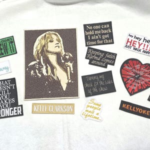 May include: A collection of rectangular, heart-shaped, and die-cut stickers featuring Kelly Clarkson imagery and song lyrics. Text includes "You blew it," "What doesn't kill you makes you stronger," "No one can hold me back," and "K.C. Studio Sessions."