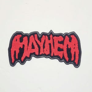 May include: Red embroidered patch with the word "MAYHEM" in a bold, stylised font. The patch has a black border.