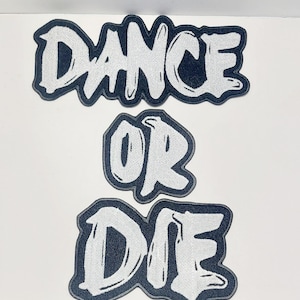 May include: Three embroidered patches with the words "DANCE", "OR", and "DIE" in a bold, stylized font. The text is white with a dark blue border, creating a striking contrast. The patches are likely for clothing or accessories.