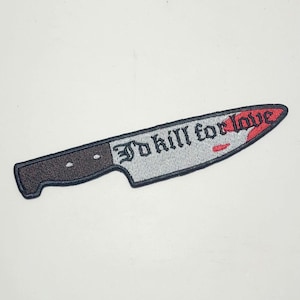 May include: Embroidered patch in the shape of a knife with a black handle and a silver blade. The blade's tip is red with a blood-like design. The text "I'd kill for love" is embroidered on the blade in black gothic lettering.