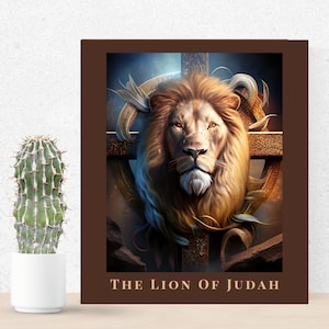 May include: A framed print depicting a lion's head with a golden mane, set against a cross and a celestial background. The text "THE LION OF JUDAH" is displayed at the bottom of the frame. A cactus in a white pot is to the left.