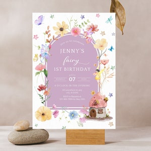 May include: A purple and white invitation card with a floral border and a fairy illustration. The text on the card reads "Join us to celebrate Jenny's fairy 1st birthday, Monday, July 07, 4 o'clock in the evening, 121 anywhere st, city 12345, RSVP to Natasha at 123-456-7890 by May 30th."