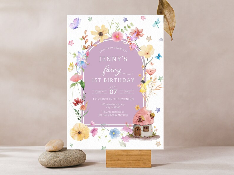 May include: A purple and white invitation card with a floral border and a fairy illustration. The text on the card reads "Join us to celebrate Jenny's fairy 1st birthday, Monday, July 07, 4 o'clock in the evening, 121 anywhere st, city 12345, RSVP to Natasha at 123-456-7890 by May 30th."
