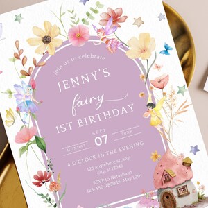 May include: A purple and white invitation with watercolor flowers and fairies. The text reads "Join us to celebrate Jenny's fairy 1st birthday, Monday, Sept 07, 20XX, 4 o'clock in the evening, 123 anywhere st, any city, st 12345, RSVP to Natasha at 123-456-7890 by May 10th".