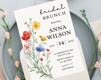 May include: A white bridal brunch invitation with a floral design featuring red, yellow, blue, and pink flowers. The text reads "bridal brunch honoring Anna Wilson Sat 24 Aug 123 Anywhere St, Any City, ST 12345 RSVP to Aaron at 123-456-7890 registered at Jones David".